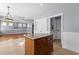 Kitchen featuring stainless steel appliances, granite counters, tile floors, and an open floor plan to the living room at 130 Virginia Water Dr, Rolesville, NC 27571