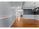 Open-concept living space with hardwood floors, decorative crown molding, and fresh paint throughout the home at 130 Virginia Water Dr, Rolesville, NC 27571