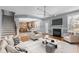 Staged living room open to kitchen with seating, fireplace, natural light and hardwood floors at 130 Virginia Water Dr, Rolesville, NC 27571