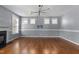 Open living room with lots of natural light, hardwood floors and modern ceiling fan at 130 Virginia Water Dr, Rolesville, NC 27571