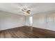 Large bedroom features ceiling fan, modern flooring, and two entry doors at 131 Hawick Ct, Zebulon, NC 27597