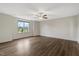 Bright and airy bedroom with hardwood floors, ceiling fan, and scenic views from a large window at 131 Hawick Ct, Zebulon, NC 27597
