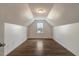Finished bonus room featuring wood-look flooring and vaulted ceilings at 131 Hawick Ct, Zebulon, NC 27597
