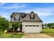 Charming home with a two-car garage, well-maintained lawn, and a mix of siding and roof shingles at 131 Hawick Ct, Zebulon, NC 27597