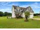 Charming two-story home with a manicured lawn, inviting curb appeal, and attached two-car garage at 131 Hawick Ct, Zebulon, NC 27597