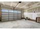 Spacious unfinished two-car garage with painted walls, exposed ceiling beams and a garage door at 131 Hawick Ct, Zebulon, NC 27597