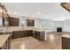Well-lit kitchen featuring stainless appliances, granite countertops, tile backsplash, and dark wood cabinets at 131 Hawick Ct, Zebulon, NC 27597