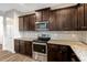 This kitchen boasts stainless steel appliances, brown cabinets, and light gray countertops at 131 Hawick Ct, Zebulon, NC 27597