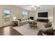 Inviting living room features a fireplace, stylish furnishings, and access to a backyard patio at 131 Hawick Ct, Zebulon, NC 27597