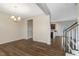 Spacious living room features hardwood flooring and a modern lighting fixture at 131 Hawick Ct, Zebulon, NC 27597