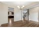 Open-concept living space with hardwood floors, modern lighting, and seamless transition to the kitchen at 131 Hawick Ct, Zebulon, NC 27597