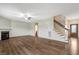 Cozy living room with fireplace, ceiling fan, and staircase leading to the upper level at 131 Hawick Ct, Zebulon, NC 27597