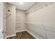 Spacious walk-in closet featuring wood-look floors and extensive white wire shelving for optimal storage at 131 Hawick Ct, Zebulon, NC 27597