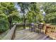 Outdoor deck features a dining table set, surrounded by a lush green backyard at 1541 Caswell St, Raleigh, NC 27608