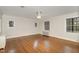 A large bedroom with wood floors, fan, and natural light at 1541 Caswell St, Raleigh, NC 27608