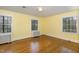 Bright bedroom featuring hardwood floors, and natural light from three windows at 1541 Caswell St, Raleigh, NC 27608