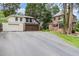 View of brick house and detached two-car garage from driveway at 1541 Caswell St, Raleigh, NC 27608