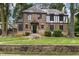 Handsome brick home with stone accents, mature trees, and a meticulously landscaped front yard at 1541 Caswell St, Raleigh, NC 27608