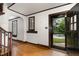 Bright foyer featuring hardwood floors, white walls, dark trim, and views of the front yard at 1541 Caswell St, Raleigh, NC 27608