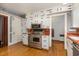 A charming kitchen with stainless steel appliances, custom cabinets, and beautiful wood flooring at 1541 Caswell St, Raleigh, NC 27608