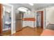 A cozy kitchen featuring stainless steel appliances and bright cabinetry with adjacent bathroom at 1541 Caswell St, Raleigh, NC 27608