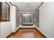Cozy bonus room with hardwood floors, large windows with natural light, and white walls with dark trim at 1541 Caswell St, Raleigh, NC 27608