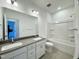Bathroom with a double sink vanity, neutral paint, and tub with shower at 1945 Plott Balsam Dr, Wendell, NC 27591