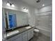 Well-lit bathroom with double sinks, white cabinets, and a shower-tub combo for convenience at 1945 Plott Balsam Dr, Wendell, NC 27591