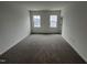 Bright, carpeted bedroom with two windows offering natural light and neutral walls ready for personalization at 1945 Plott Balsam Dr, Wendell, NC 27591