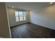 Bedroom featuring neutral paint, wood floors, and a large window for natural light at 1945 Plott Balsam Dr, Wendell, NC 27591