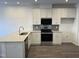 Bright kitchen with stainless steel appliances, granite countertops and classic white cabinets at 1945 Plott Balsam Dr, Wendell, NC 27591