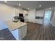 Open concept kitchen with stainless steel appliances, granite countertops and wood floors at 1945 Plott Balsam Dr, Wendell, NC 27591