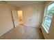 Bright room featuring a carpet, window, and closet doors, ready for final touches at 1985 Rabbitbrush St, Durham, NC 27704