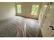 Bright bedroom featuring carpet, two windows, and closet doors, awaiting personal touches at 1985 Rabbitbrush St, Durham, NC 27704