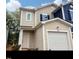 Inviting townhouse featuring neutral siding, black shutters, and a convenient attached garage at 1985 Rabbitbrush St, Durham, NC 27704