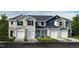 Charming townhouse featuring varied siding styles, inviting entrances, and attached single-car garages at 1985 Rabbitbrush St, Durham, NC 27704