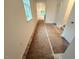 Bright hallway leads to living area, showcasing natural light and prepped flooring ready for finishing at 1985 Rabbitbrush St, Durham, NC 27704