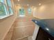 Sunlit living space with large windows, sliding door and prepped flooring ready for finishing at 1985 Rabbitbrush St, Durham, NC 27704