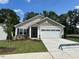 Inviting single-Gathering home with manicured lawn, covered entryway, and a two-car garage at 201 Jetson Creek Way, Youngsville, NC 27596