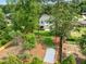 An aerial view shows the large backyard, mature trees, and a patio area off the back of the home at 217 Dublin Rd, Raleigh, NC 27609