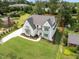 New home aerial view, featuring manicured lawn, lush landscaping, and a spacious driveway at 217 Dublin Rd, Raleigh, NC 27609