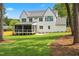 Backyard of home with screened in porch, patio and large lush green yard at 217 Dublin Rd, Raleigh, NC 27609