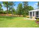 Expansive backyard with lush green grass, wood fence, and a screened-in porch at 217 Dublin Rd, Raleigh, NC 27609