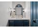 Elegant powder room features a blue vanity, marble countertop, and sleek, modern lighting at 217 Dublin Rd, Raleigh, NC 27609