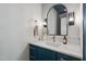 Stylish powder room with marble countertop, blue vanity, modern fixtures and decorative mirror at 217 Dublin Rd, Raleigh, NC 27609