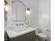 Stylish powder room featuring modern fixtures, a unique vanity, and decorative wall paneling at 217 Dublin Rd, Raleigh, NC 27609