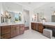 Spacious bathroom featuring double vanities, modern lighting, and a view of the outdoor scenery at 217 Dublin Rd, Raleigh, NC 27609