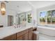 Bright bathroom with a double vanity, soaking tub, and modern fixtures at 217 Dublin Rd, Raleigh, NC 27609