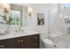 Bright bathroom featuring a modern vanity with stylish fixtures and a glass-enclosed shower at 217 Dublin Rd, Raleigh, NC 27609