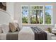 Cozy bedroom with a large window offering views of trees, a comfortable bed, and neutral decor at 217 Dublin Rd, Raleigh, NC 27609